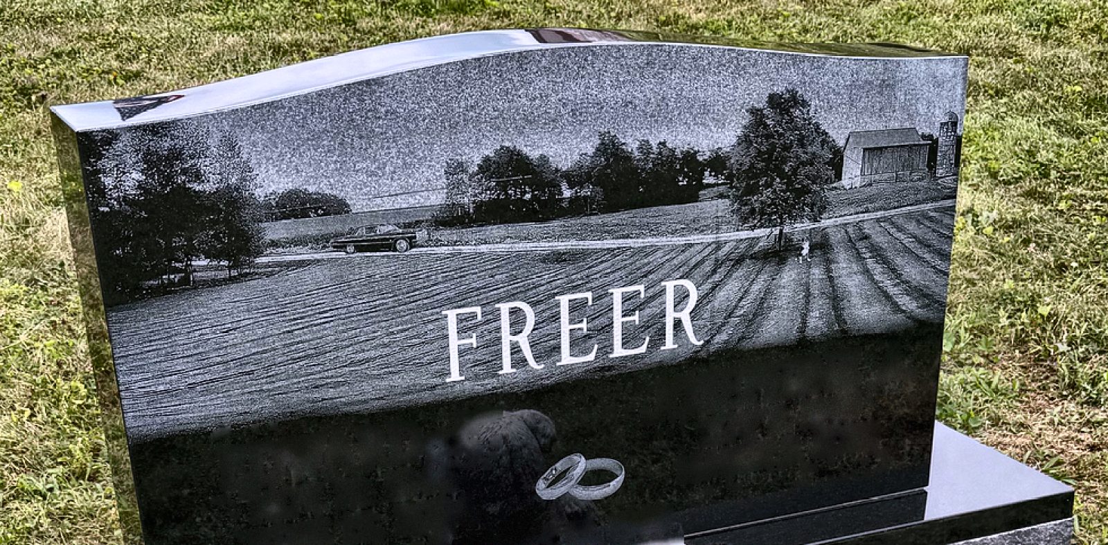 Black granite upright with etched farm scene